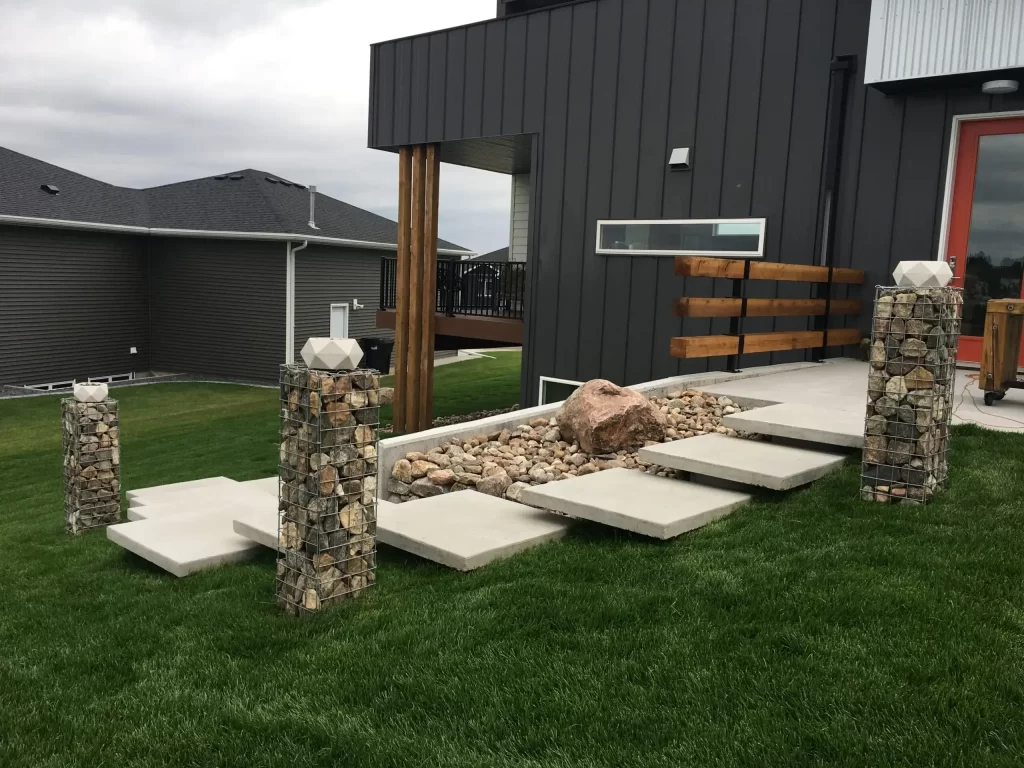 Concrete floating steps with rock columns in backyard
